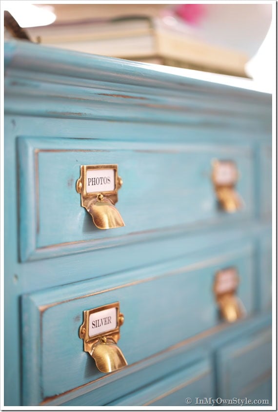 Brass-Label-Holders-and-Drawer-Pulls-from-Van-Dykes-Restorers all finished on turquoise sideboard.