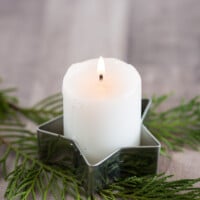 A votive candle placed inside a metal cookie cutter makes for fast and easy Christmas decor