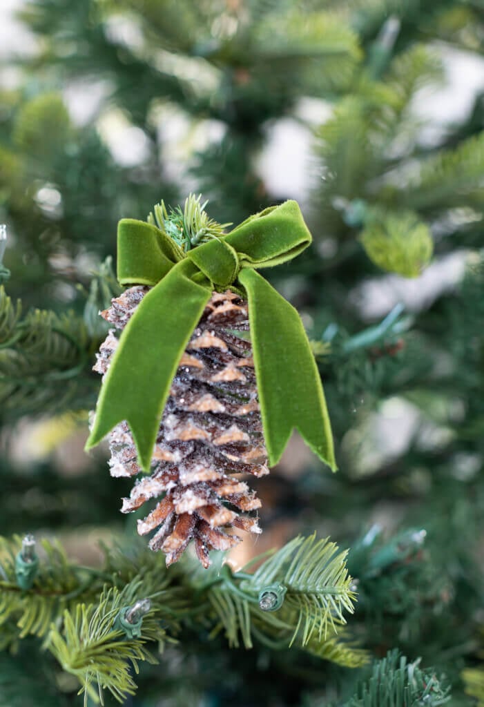 Close up of pinecone made into a Christmas tree ornament.