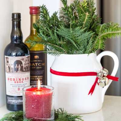 ribbon and jingle bell Christmas decoration on a white pitcher