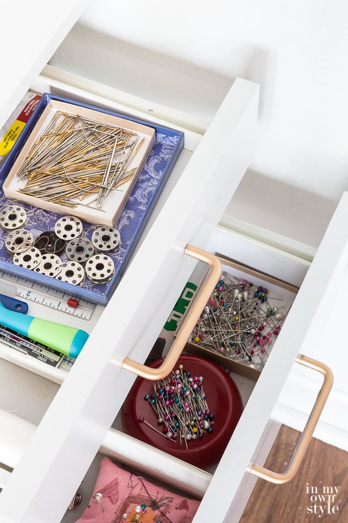 Organized drawers in craft room sewing corner.