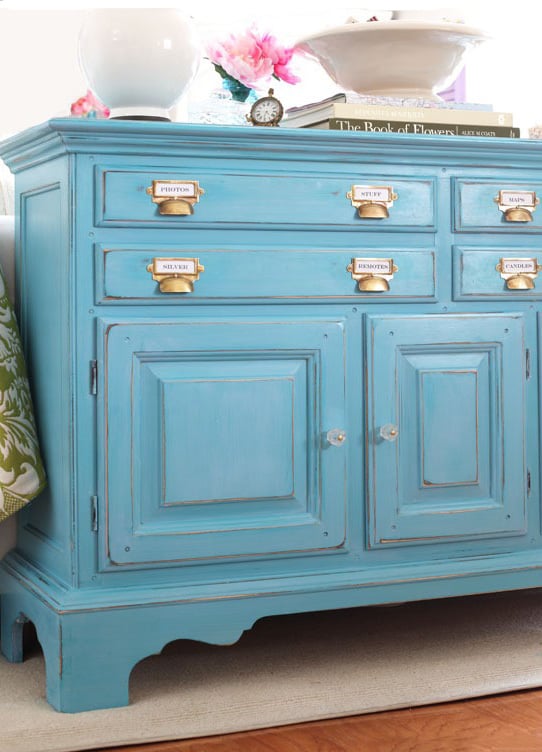 A turquoise side board that was painted with the DIY chalk paint recipe using calcium carbonate powder.