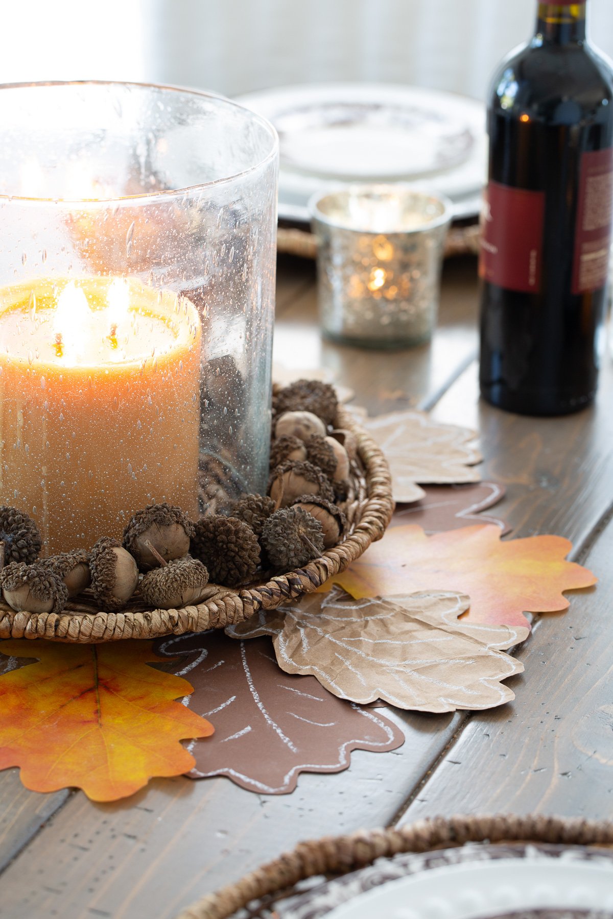 Cut out paper leaves made into a Thanksgiving table centerpiece.