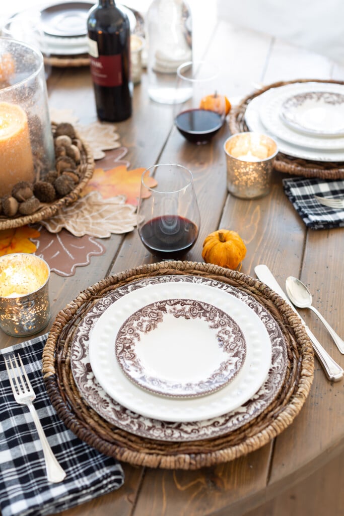 brown paper oak leaf place card on top of a dinner plate on a table