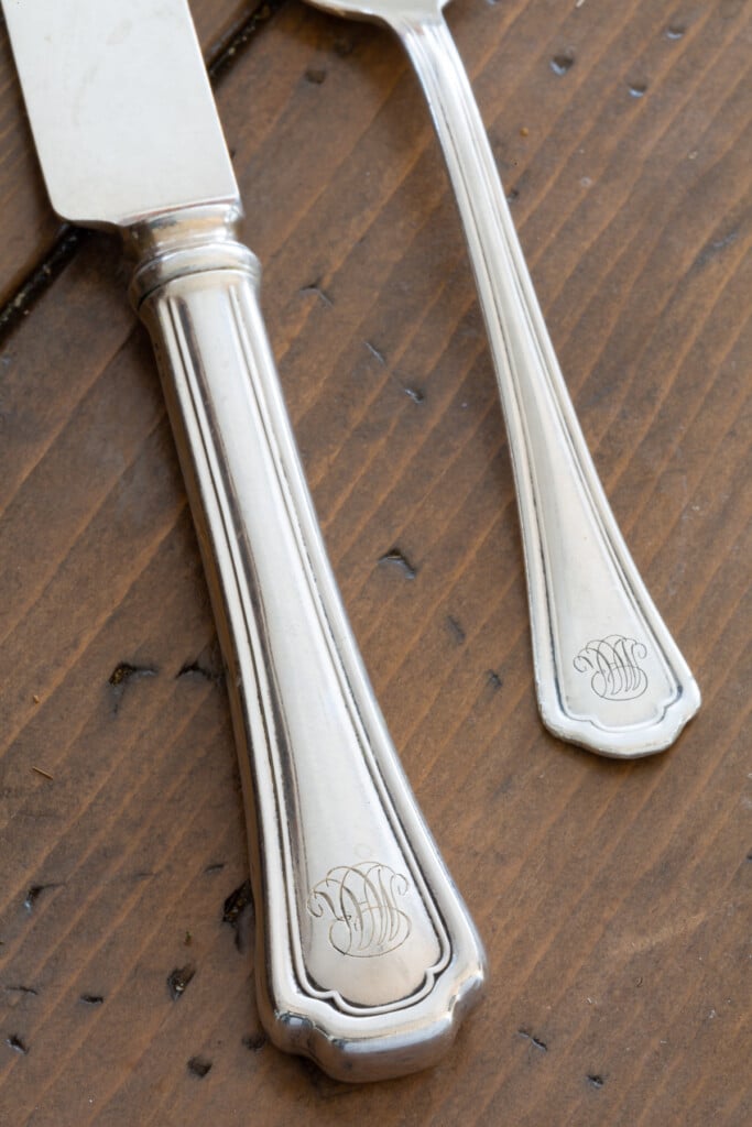 monogramed silverware on a dining table