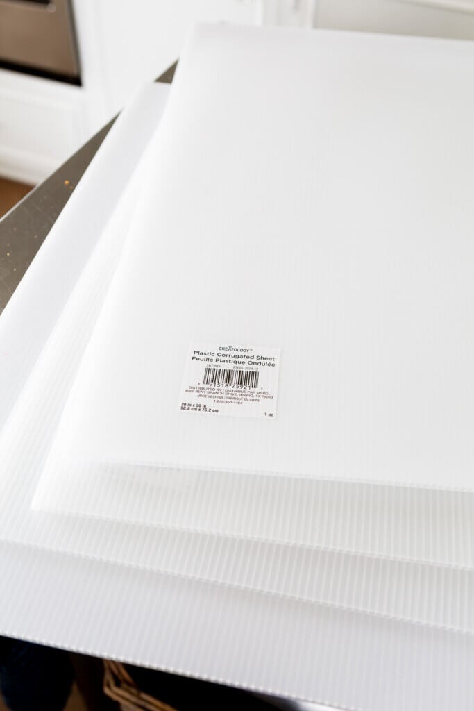 3 white corrugated sheets on a worktable.