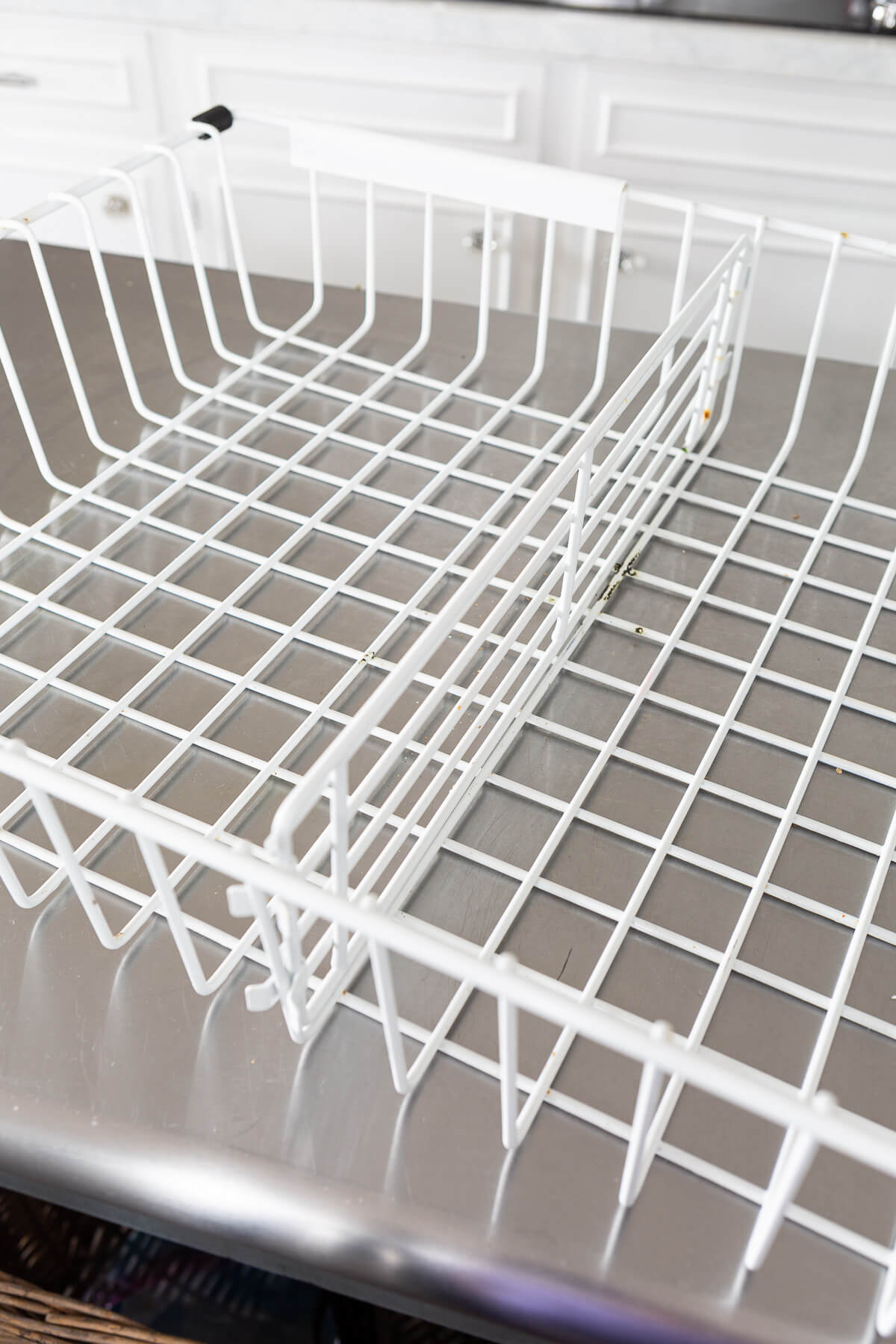 White coated wire Freezer drawer basket on table.