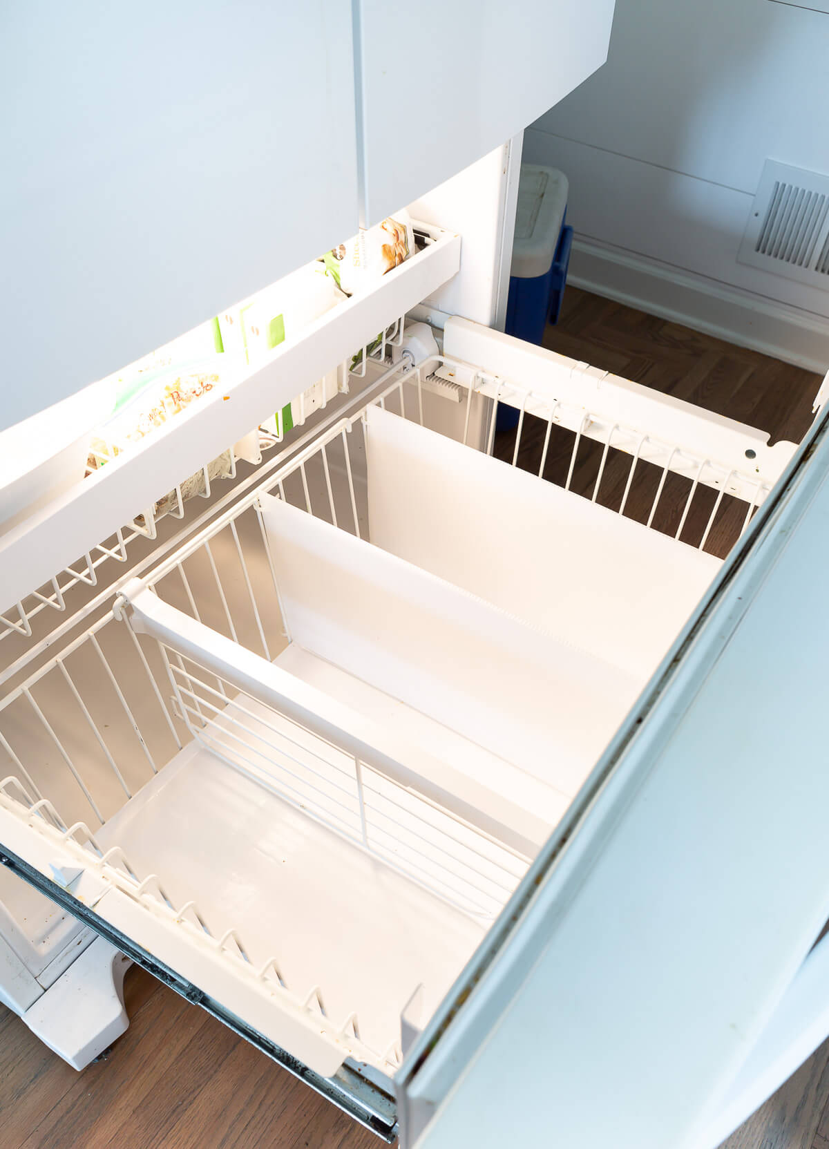 plastic freezer dividers in bottom drawer of freezer.