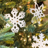 Paper Snowflakes hanging on a Christmas tree made using paper doilies