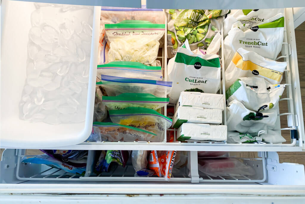 Looking down into a newly organized bottom drawer freezer.