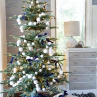 7' King Noble Fir Artificial Christmas Tree in blue and white bedroom.