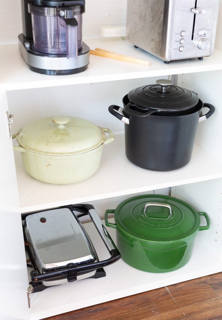 large and heavy pots stored in a cabinet in new room where half will act as a butler's pantry.