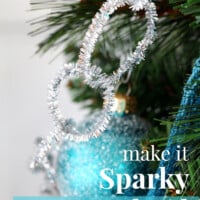 Christmas decorating on a budget. Sparkly silver pipe cleaner Christmas tree garland to make. Fast and affordable Christmas decor. ideas. Text overlay say make it Sparkly Tree Garland