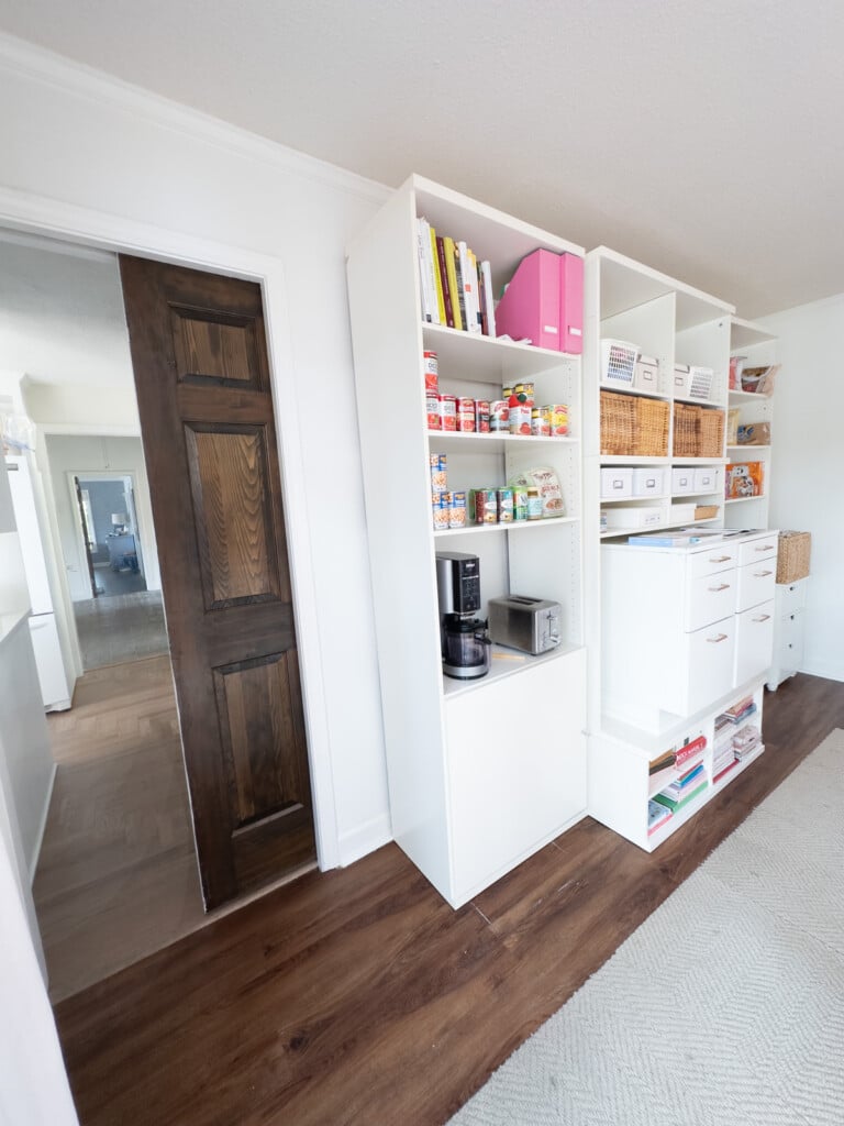 Pocket door in doorway of a room used for kitchen storage and a DIY decorator studio.