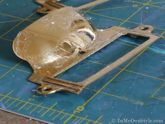 Gummy lacquer being removed from brass with acetone