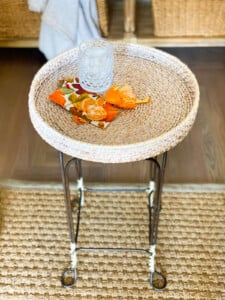 vintage metal stool with round wicker tray on top becomes a unique table.