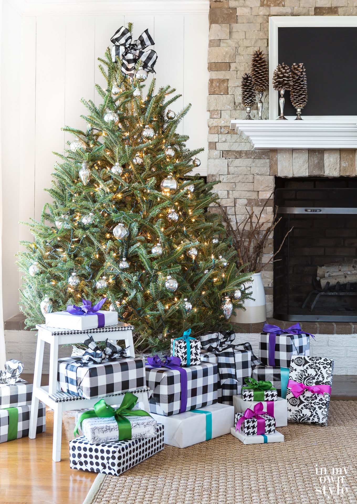 Simply decorated real Christmas tree with white twinkle lights and silver mercury glass ornaments