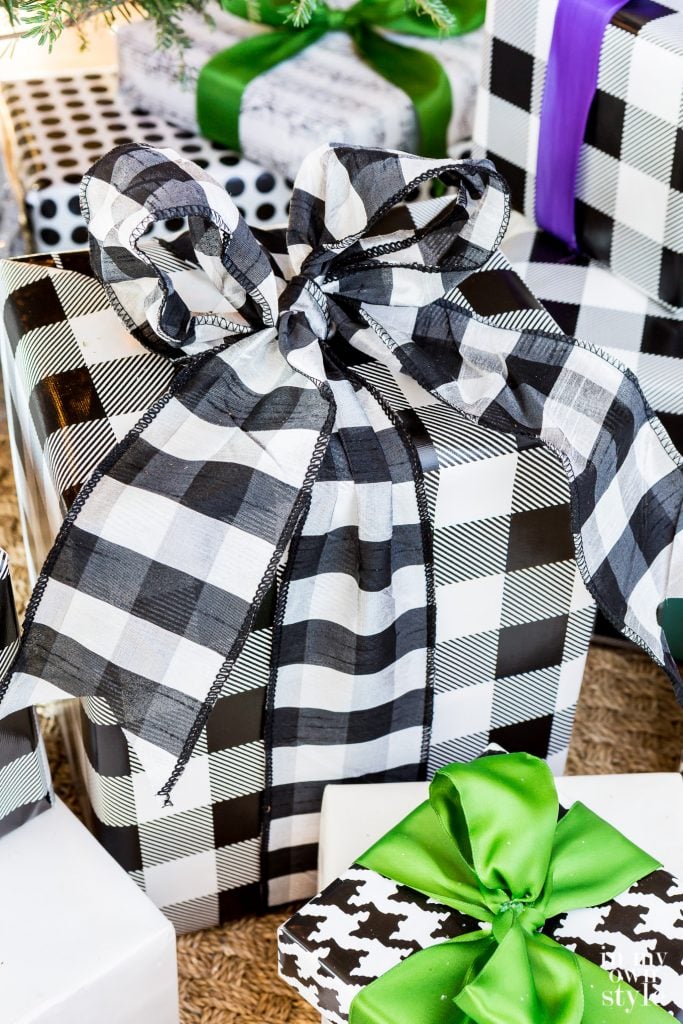 Black and white buffalo plaid ribbon on gift wrap of the same design