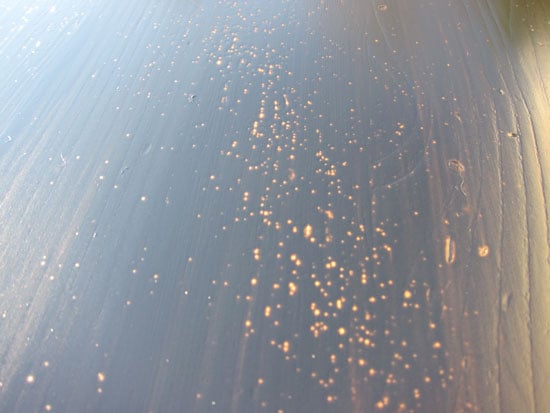 air bubbles showing up in first coat of black stain on table after it dried.