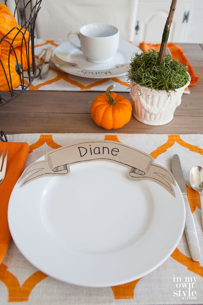 Affordable entertaining idea for setting a table with unique place cards that you place on dinner plates. Your guests will want to take them home.